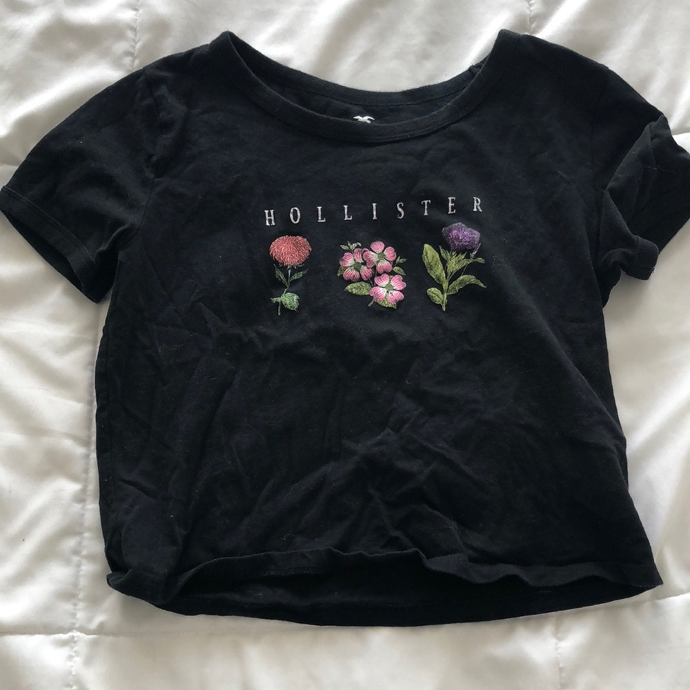 Hollister black top with flowers on the front